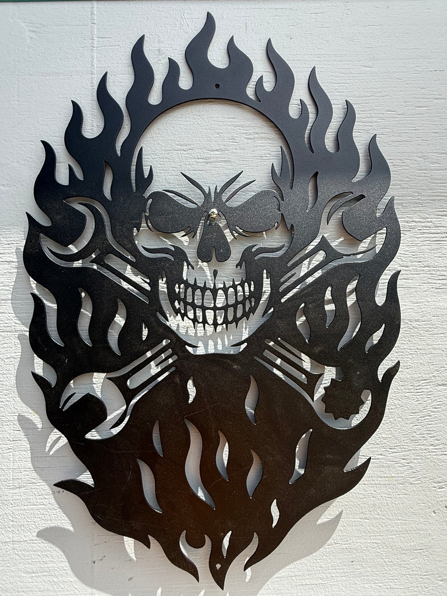 Skull with flames and wrenches sign