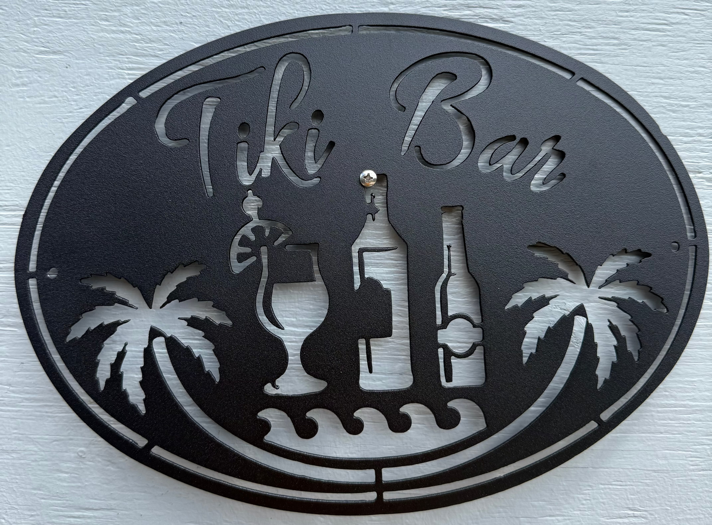 Decorative metal sign with 'Tiki Bar' text and tiki bar elements.